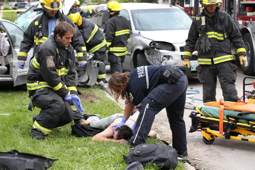 Fire and Paramedics scheck a alleged drunk driver who blew through a stop sign at high speeds and crashed into two cars- He then banished a knife saying he wanted to get out of here because he was drunk( He is pinned on ground on right of photo)-See Alex Paul- Sept 17, 2014   (JOE BRYKSA / WINNIPEG FREE PRESS)