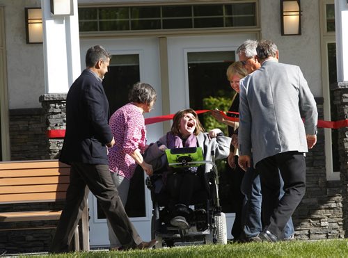 An ecstatic Shauna Preece gets ready to cut the ribbon to officially open the $1M Spirit Cottage by Hans Kraus Family & Qualico, a four-season fully accessible cottage for the 1700 individuals St.Amant.  The cottage is equipped with lifts, a wheelchair ramp, three bedrooms and outside there is an in-ground pool and a fire pit. The cottage will provide individuals with developmental disabilities and autism, and their families, recreation and leisure activities surrounded by nature.  Wayne Glowacki/Winnipeg Free Press Sept.18  2014