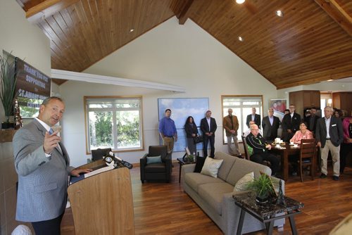 At left John Leggat, President & CEO, St.Amant points out the outdoor fire pit during the official opening of the $1M Spirit Cottage by Hans Kraus Family & Qualico, a four-season fully accessible cottage for the 1700 individuals St.Amant. The cottage is equipped with lifts, a wheelchair ramp, three bedrooms and outside there is an in-ground pool. The cottage will provide individuals with developmental disabilities and autism, along with their families, recreation and leisure activities surrounded by nature. Wayne Glowacki/Winnipeg Free Press Sept.18 2014 ¤