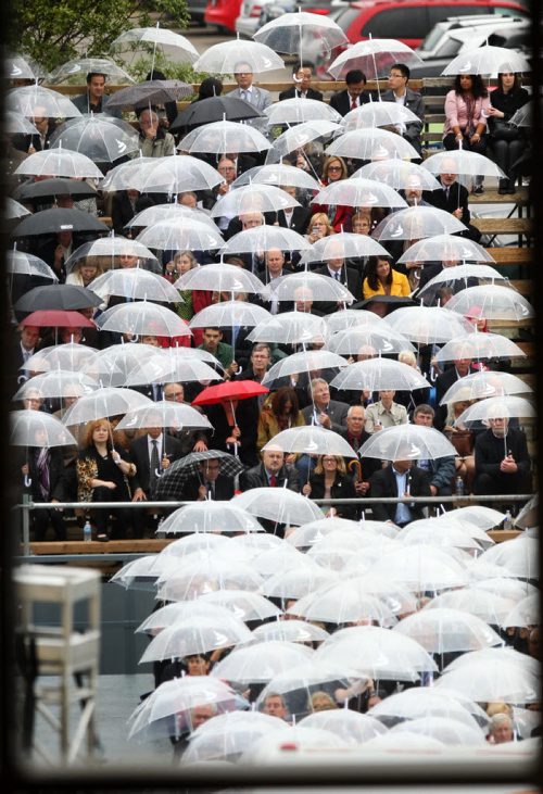 CMHR Ceremony - Friends of the museum, politicians and dignitaries  cover themselves with umbrellas in the rain as they attend the opening ceremonies for the Canadian Museum for Human Rights  Friday.  Sept 19,  2014 Ruth Bonneville / Winnipeg Free Press