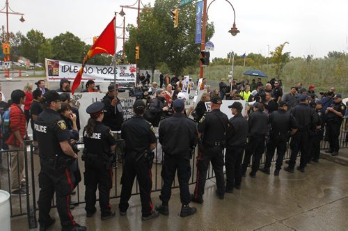 Winnipeg Police watch demonstrators outside the Canadian Museum for Human Rights during the official opening ceremonies Friday. Mary Agnes Welch story.¤Wayne Glowacki/Winnipeg Free Press Sept.19 2014
