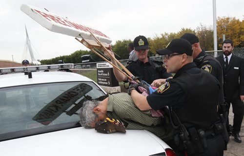 A protestor is arrested by Winnipeg Police Friday afternoon while protesting outside the Canadian Museum of Human Rights- Today was the museums opening day-Breaking News- Sept 19, 2014   (JOE BRYKSA / WINNIPEG FREE PRESS)