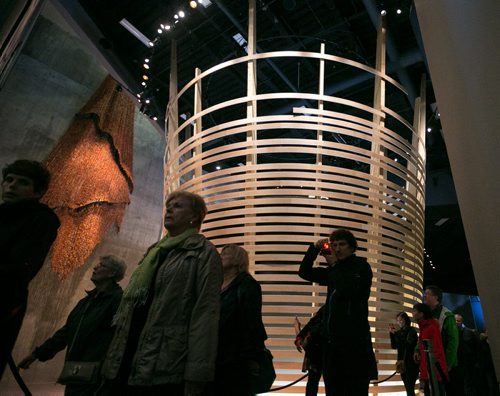 Visitors walk past the inverted woven basket in the Indigenous Perspectives gallery at the Canadian Museum for Human Rights on Saturday. Thousands had reserved tickets for the four gallery preview tour on Saturday and Sunday. That is only four of 11 galleries, the rest of which open September 27th. 140920 - Saturday, September 20, 2014 - (Melissa Tait / Winnipeg Free Press)