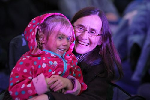 Five year old Alina Weins giggles with her grandmother Kathy Redekopp while watching performers on the main stage during the Rights Fest at the Forks Saturday night.  Sept 20,  2014 Ruth Bonneville / Winnipeg Free Press