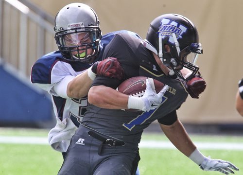 Winnipeg Rifles play the Regina Thunder at the Investors Group Field Sunday afternoon. Winnipeg Rifles' Julian Banares (1) is pulled down by Regina Thunders' Royce Hanna (30) in the second quarter. 140921 - Sunday, September 21, 2014 -  (MIKE DEAL / WINNIPEG FREE PRESS)