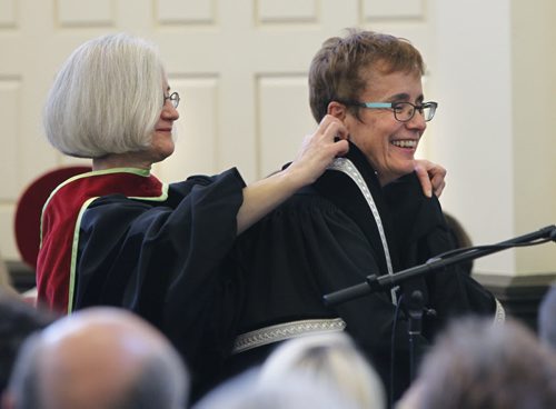 At left, Dr. Wendy Josephson places the robe on Dr. Annette Trimbee, the new pres. and Vice-Chancellor of the University of Winnipeg during the Presidential Inauguration ceremony held at the U of W  Monday.   Nick Martin story.¤Wayne Glowacki/Winnipeg Free Press Sept. 22  2014