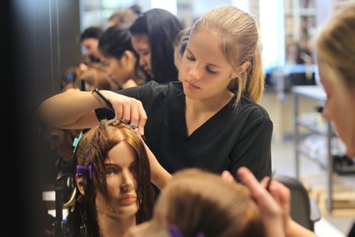 Grade 10 student Ashley Chaput  learns hairstyling in the cosmetology program at The Steinbach Regional Secondary School which celebrated its Grand Opening of facility Tuesday with Premier Greg Selinger and Education Minister - James Allum.   Sept 23,  2014 Ruth Bonneville / Winnipeg Free Press