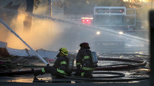 City firefighters battle a blaze at 27 Apple Lane after an explosion sent one man to hospital in critical condition. The entire north wall was blown out and second story caved in.... See Ashley Prest story. September 23, 2014 - (Phil Hossack / Winnipeg Free Press)