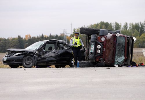 MVC on  Hwy 6 at Hwy 322  has two heavily damages vehicles , a car with front and driver side damage  and a jeep on it's side  , RCMP are investigating , it's Forensic Collision Reconstruction unit is on scene , both roads are open  as police are slowing  traffic around the  damaged cars  .  SEPT  24 2014 / KEN GIGLIOTTI / WINNIPEG FREE PRESS
