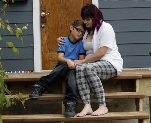 LOCAL - stolen bike .Mother  Rochelle Richardsand  nine-year-old Shaden whose special needs bike adapted for his cerebral palsy was stolen yesterday around supper time from in front of his house last night with his mom, Rochelle Richards. Shaden was too upset to go to school today.SEPT  24 2014 / KEN GIGLIOTTI / WINNIPEG FREE PRESS