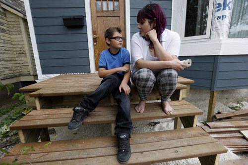LOCAL - stolen bike .Mother  Rochelle Richardsand  nine-year-old Shaden whose special needs bike adapted for his cerebral palsy was stolen yesterday around supper time from in front of his house last night with his mom, Rochelle Richards. Shaden was too upset to go to school today.SEPT  24 2014 / KEN GIGLIOTTI / WINNIPEG FREE PRESS