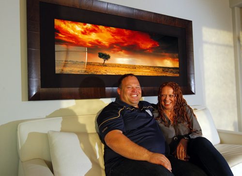 49.8 FEATURE - Wade Miller and his partner Melissa Malden collect art photography. Here they pose for a photo with one on the wall behind them.  BORIS MINKEVICH / WINNIPEG FREE PRESS  Sept. 24, 2014