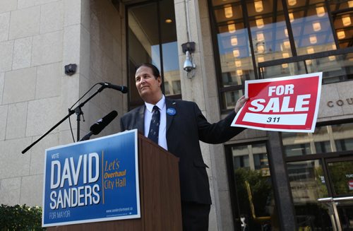 Mayoral candidate David Sanders holds a For Sale sign with 311 on it to illustrate the problems with the 311 call in system at City Hall during presser at City Hall Thursday.   See Aldo Santin's story.   Sept 24,  2014 Ruth Bonneville / Winnipeg Free Press