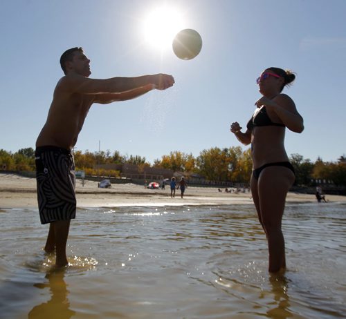 Paul Tietz and Jenn Bach play some volleyball at Grand Beach. Warm weather drove the two from Portage la Prairie to catch a little bit of summer delivered to Manitobans in late September.  BORIS MINKEVICH / WINNIPEG FREE PRESS  Sept. 25, 2014
