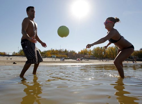 Paul Tietz and Jenn Bach play some volleyball at Grand Beach. Warm weather drove the two from Portage la Prairie to catch a little bit of summer delivered to Manitobans in late September.  BORIS MINKEVICH / WINNIPEG FREE PRESS  Sept. 25, 2014