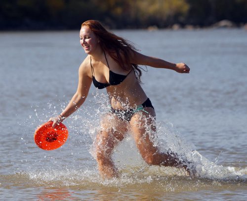 Courtney Fielding of Selkirk, MB plays a little frisbee on the beach at Grand Beach with a friend. A little bit of summer delivered to Manitobans in late September.  BORIS MINKEVICH / WINNIPEG FREE PRESS  Sept. 25, 2014