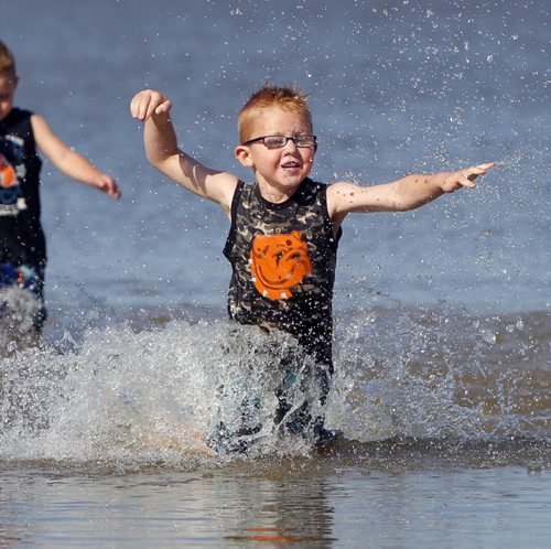 Seth Fraser,5,  enjoys the water at Grand Beach with his family. A little bit of summer delivered to Manitobans in late September.  BORIS MINKEVICH / WINNIPEG FREE PRESS  Sept. 25, 2014