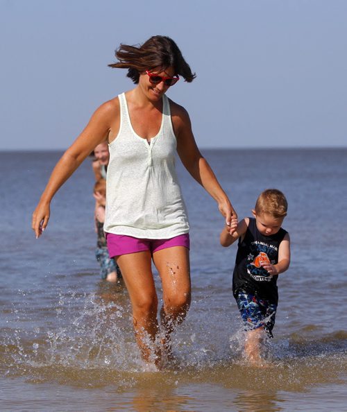 Neoma Green in the water with Ryder Fraser,3, at Grand Beach with his family. Green is a family friend. A little bit of summer delivered to Manitobans in late September.  BORIS MINKEVICH / WINNIPEG FREE PRESS  Sept. 25, 2014