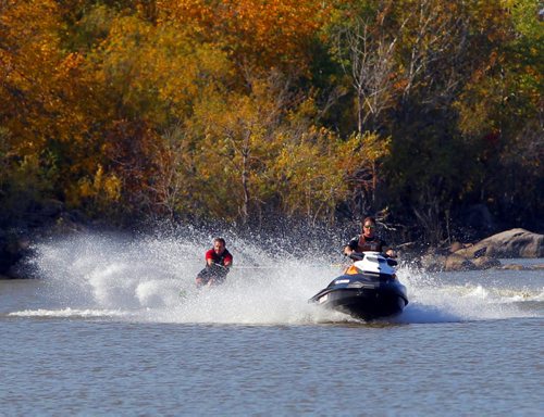 Casey Case dives a Seadoo pulling Brad Pfledger behind on a waterski. A little bit of summer delivered to Manitobans in late September.  BORIS MINKEVICH / WINNIPEG FREE PRESS  Sept. 25, 2014