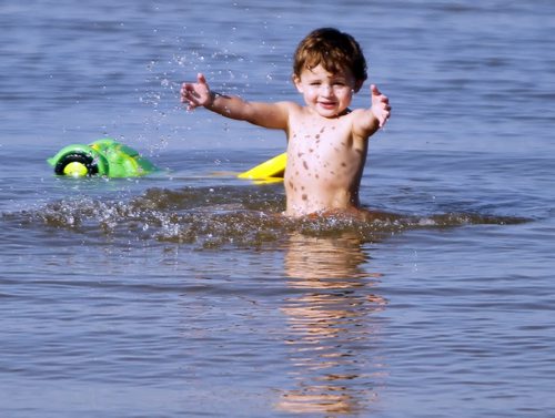 Lucik Brisebois,2, splashes around at Grand Beach. A little bit of summer delivered to Manitobans in late September.  BORIS MINKEVICH / WINNIPEG FREE PRESS  Sept. 25, 2014