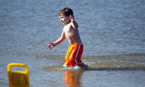 Lucik Brisebois,2, splashes around at Grand Beach. A little bit of summer delivered to Manitobans in late September.  BORIS MINKEVICH / WINNIPEG FREE PRESS  Sept. 25, 2014