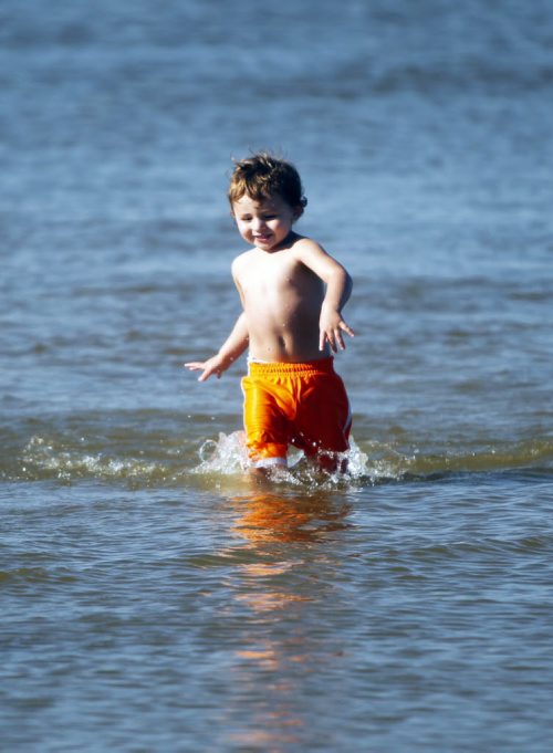 Lucik Brisebois,2, splashes around at Grand Beach. A little bit of summer delivered to Manitobans in late September.  BORIS MINKEVICH / WINNIPEG FREE PRESS  Sept. 25, 2014