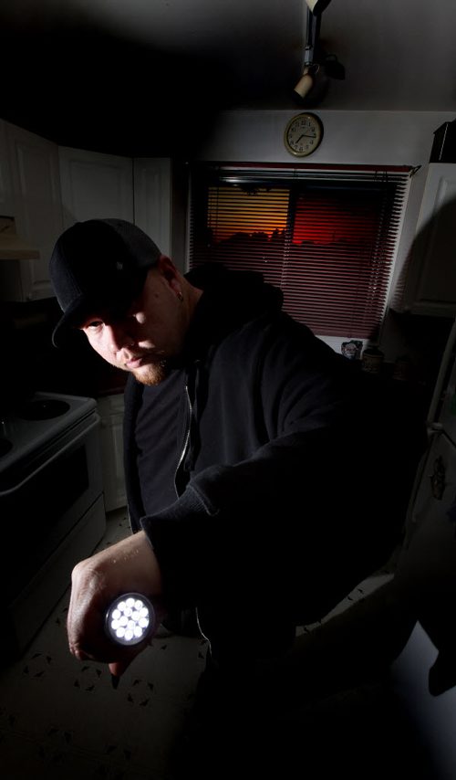 Adam Dereger-Dejarlais poses with one of the tools (a flashlight) of his ghost finding trade Thursday. Adam is the founder of Paranormal Seekers of Winnipeg - a group of ghost-busters - only, don't call them that - that fields calls from concerned citizens who think their home, place of work, doghouse, etc. is haunted. So Adam and his team - yes, he  has a team - move in and try to provide proof that they do or don't have a ghost problem. (Adam used to be part of a separate group but he is now branching out on his own - seems Winnipeg is haunted enough there's room for two paranormal societies...)See Sanderson's story. September 25, 2014 - (Phil Hossack / Winnipeg Free Press)