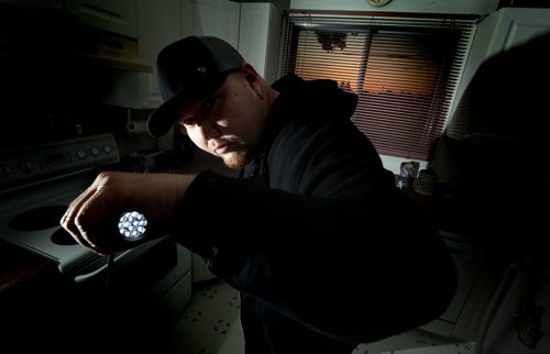 Adam Dereger-Dejarlais poses with one of the tools (a flashlight) of his ghost finding trade Thursday. Adam is the founder of Paranormal Seekers of Winnipeg - a group of ghost-busters - only, don't call them that - that fields calls from concerned citizens who think their home, place of work, doghouse, etc. is haunted. So Adam and his team - yes, he  has a team - move in and try to provide proof that they do or don't have a ghost problem. (Adam used to be part of a separate group but he is now branching out on his own - seems Winnipeg is haunted enough there's room for two paranormal societies...) See Sanderson's story. September 25, 2014 - (Phil Hossack / Winnipeg Free Press)
