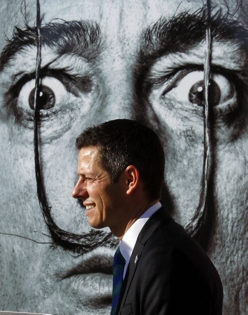 Mayoral Candidate Brian Bowman passes by Salvador Dali poster after making a policy announcement outside the Winnipeg Art Gallery Friday morning. Aldo Santin story Wayne Glowacki/Winnipeg Free Press Sept.26 2014