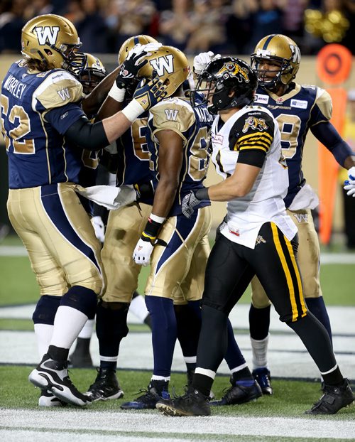 The Winnipeg Blue Bombers' celebrate a touchdown by Cory Watson (81) against the Hamilton Tiger-Cats' during second half CFL football action at Investors Group Field in Winnipeg, Saturday, September 27, 2014. (TREVOR HAGAN/WINNIPEG FREE PRESS)