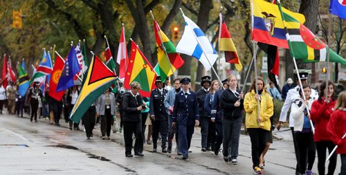 UN representatives walk along with Police officers as they march down Broadway towards the Legislative Building, Sunday, September 28, 2014. (TREVOR HAGAN/WINNIPEG FREE PRESS)