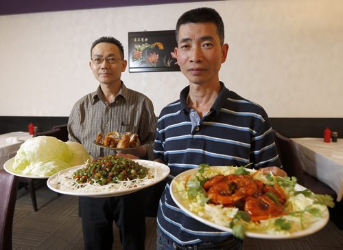 REST REVIEW - SAM PO for Review . SAM PO RESTAURANT 277 Rupert Ave.- LtoR  Mgr. Wai Ng holding Brazed prawns in Tomato Sauce, with owner  Wu Yu  holding  speciality dishes Diced duck,   & Lobster Roll . SEPT  29 2014 / KEN GIGLIOTTI / WINNIPEG FREE PRESS