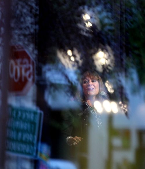 Framed in reflections, Gail Asper speaks at a reception for MTC Artistic Director Steven Schipper at the Theatre Monday Evening. Schipper has been the Director for 25 years. See release/story. September 29, 2014 - (Phil Hossack / Winnipeg Free Press)