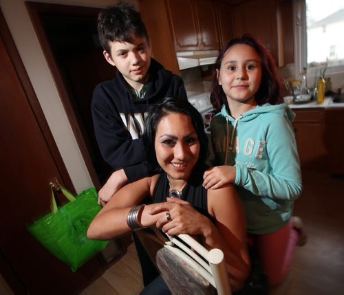 Monique Curci poses with her son Dillan and daughter Riley in the Elmwood home Wednesday. See Geoff Kirbyson story. October 30, 2014 - (Phil Hossack / Winnipeg Free Press)