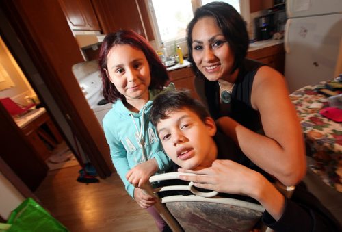 Monique Curci poses with her son Dillan and daughter Riley in the Elmwood home Wednesday. See Geoff Kirbyson story. October 30, 2014 - (Phil Hossack / Winnipeg Free Press)