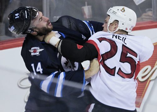 Winnipeg Jets' Anthony Peluso (14) and Ottawa Senators' Chris Neil (25) knock each other around during third period pre-season NHL action in Winnipeg on Monday, September 30, 2014. (John Woods / WINNIPEG FREE PRESS)