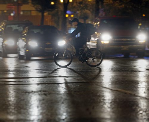 Stdup Ride in the Rain .Stdup . The first day of October brought windy and wet  weather , high of 17 OCT.1 2014 / KEN GIGLIOTTI / WINNIPEG FREE PRESS