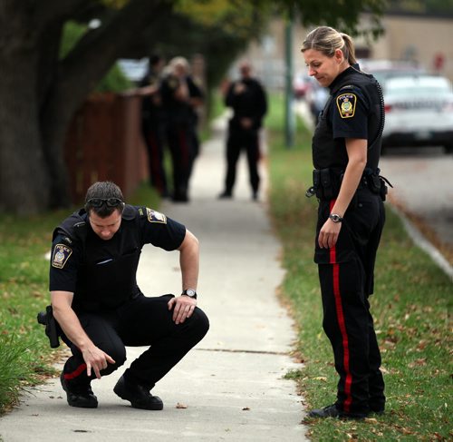 City Police officers survey the area in the 500 block of Chalmers east of Elmwood Collegiate Wednesday afternoon after a reported stabbing at or near the school. See Ashley Prest's story. October 1, 2014 - (Phil Hossack / Winnipeg Free Press)