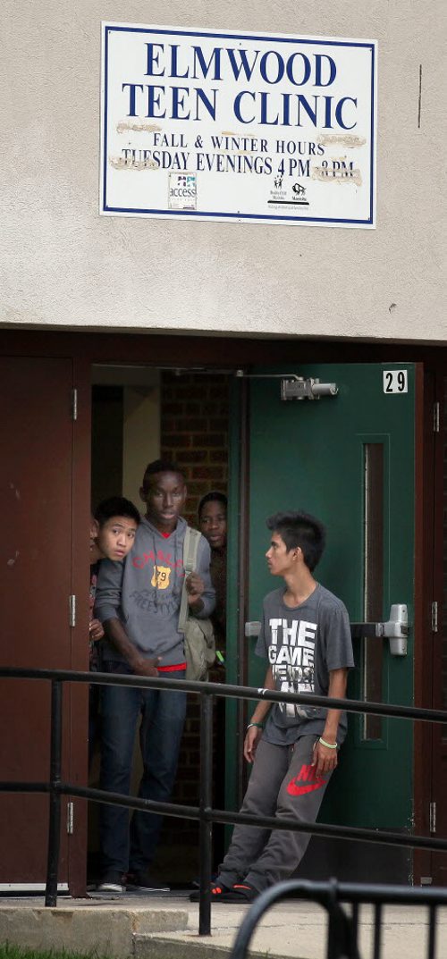 Teens peer out of the Elmwood Teen Clinic at Elmwood Collegiate Wednesday afternoon after a reported stabbing at or near the school. See Ashley Prest's story. October 1, 2014 - (Phil Hossack / Winnipeg Free Press)