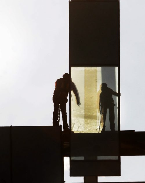 Workers lower giant glass panel into place on walkway under construction to the new HSC Womens hospital over William AveStandup Photo- Oct 02, 2014   (JOE BRYKSA / WINNIPEG FREE PRESS)