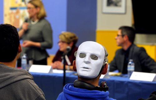 Mayoral forum at Rossbrook House. A person in the crowd wears a mask on the back of his head. BORIS MINKEVICH / WINNIPEG FREE PRESS  Oct. 2, 2014