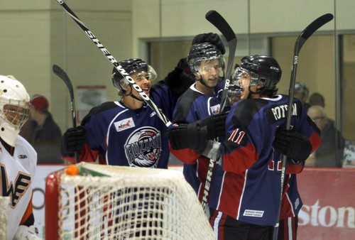 OCN Blizzard celebrate their 2nd goal in the game against the Winkler Flyers Friday afternoon at the IcePlex as the two teams met in the Old DUtch MJHL Showcase.  October 3, 2014 - (Phil Hossack / Winnipeg Free Press)