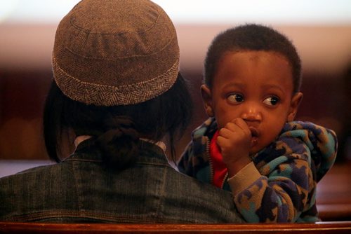 Edwin Neche, 14 mo, sitting with his mother, Liliosa, and father, Emanuel, not shown, at Knox United Church during a "Call for Prayer" for the Ebola crisis in West Africa, Friday, October 3, 2014. (TREVOR HAGAN/WINNIPEG FREE PRESS)