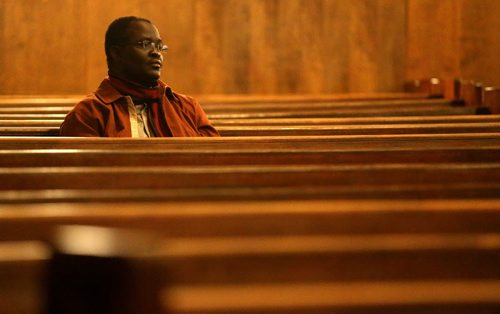 Pastor Samuel Akanbi sits at Knox United Church during a "Call for Prayer" for the Ebola crisis in West Africa, Friday, October 3, 2014. (TREVOR HAGAN/WINNIPEG FREE PRESS)