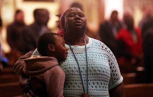 Afaf Abodigin and her son Isaiah,4, at Knox United Church during a "Call for Prayer" for the Ebola crisis in West Africa, Friday, October 3, 2014. (TREVOR HAGAN/WINNIPEG FREE PRESS)