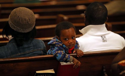 Edwin Neche, 14 mo, sitting with his mother, Liliosa, and father, Emanuel, at Knox United Church during a "Call for Prayer" for the Ebola crisis in West Africa, Friday, October 3, 2014. (TREVOR HAGAN/WINNIPEG FREE PRESS)