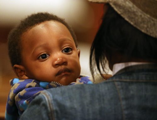 Edwin Neche, 14 mo, sitting with his mother, Liliosa, and father, Emanuel, not shown, at Knox United Church during a "Call for Prayer" for the Ebola crisis in West Africa, Friday, October 3, 2014. (TREVOR HAGAN/WINNIPEG FREE PRESS)