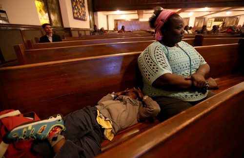 Afaf Abodigin and her son Isaiah, 4, at Knox United Church during a "Call for Prayer" for the Ebola crisis in West Africa, Friday, October 3, 2014. (TREVOR HAGAN/WINNIPEG FREE PRESS)