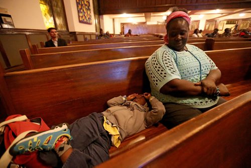Afaf Abodigin and her son Isaiah, 4, at Knox United Church during a "Call for Prayer" for the Ebola crisis in West Africa, Friday, October 3, 2014. (TREVOR HAGAN/WINNIPEG FREE PRESS)