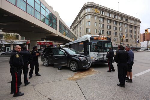 Police on the scene of an accident involving a transit bus and an SUV at the corner of Portage Avenue and Vaughan Street, Saturday, October 4, 2014. Westbound traffic on Portage is being detoured.(TREVOR HAGAN/WINNIPEG FREE PRESS)